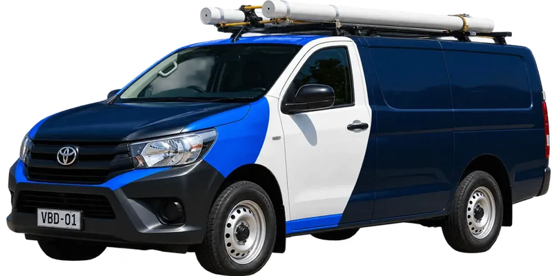 A licensed Prospect plumbing van loaded with pipe on the roof rack